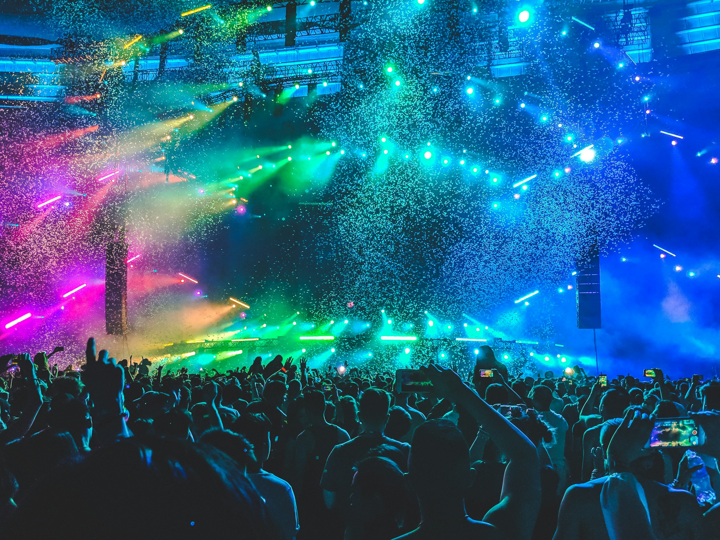 Concert crowd beneath colorful stage lights and confetti at Contact Festival in Vancouver