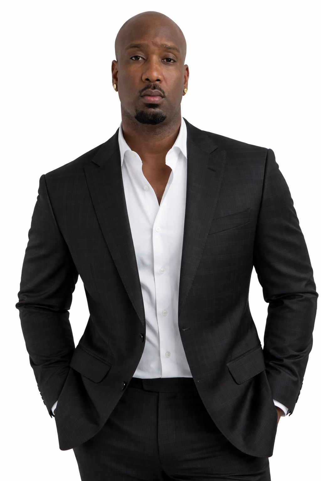 Jevaughn Laing wearing a black suit and open-collar white shirt
