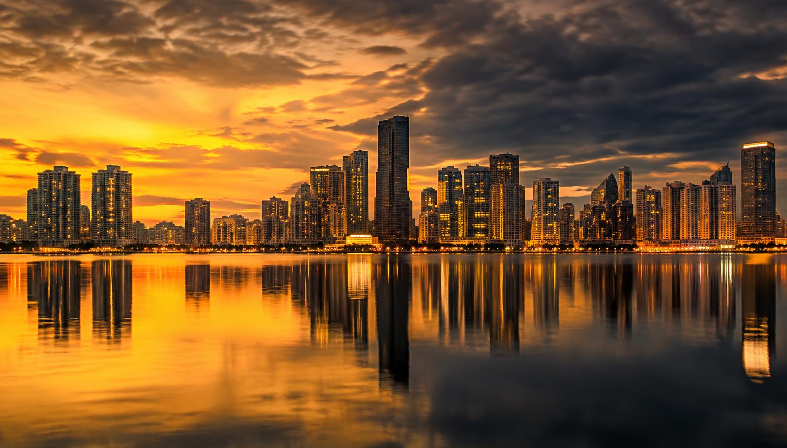 Florida city skyline reflected on water at dusk